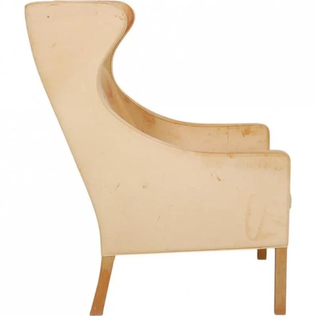 Børge Mogensen wingchair, model 2204, upholstered with original natural leather and with legs of oak. The chair is from...