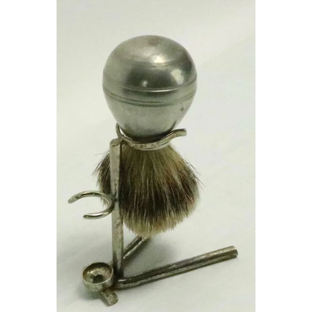 Nice antique Sheffield shaving brush on silver plate stand. The brush is stamped Sheffield, the stand is unmarked. Both...