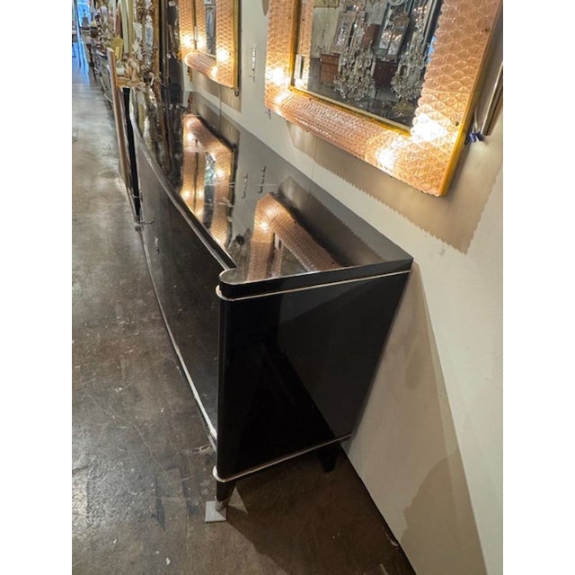 The product is a vintage Art Deco style sideboard in a piano black finish by De Coene Freres of Belgium in the mid-20th...