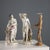 A pair of polychrome porcelain sculptures depicting allegories. The sculptural rendering of the bodies and garments is...