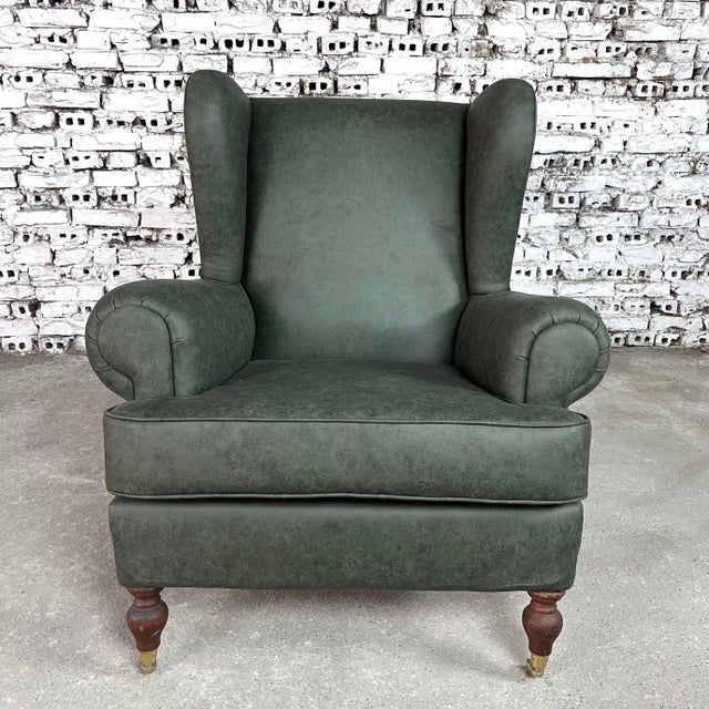 Dimensions: H 38.9” x W 36.8” x SD 23.6” x SH 20" Dutch Wingback armchair with roll arms and front legs on caster wheels....