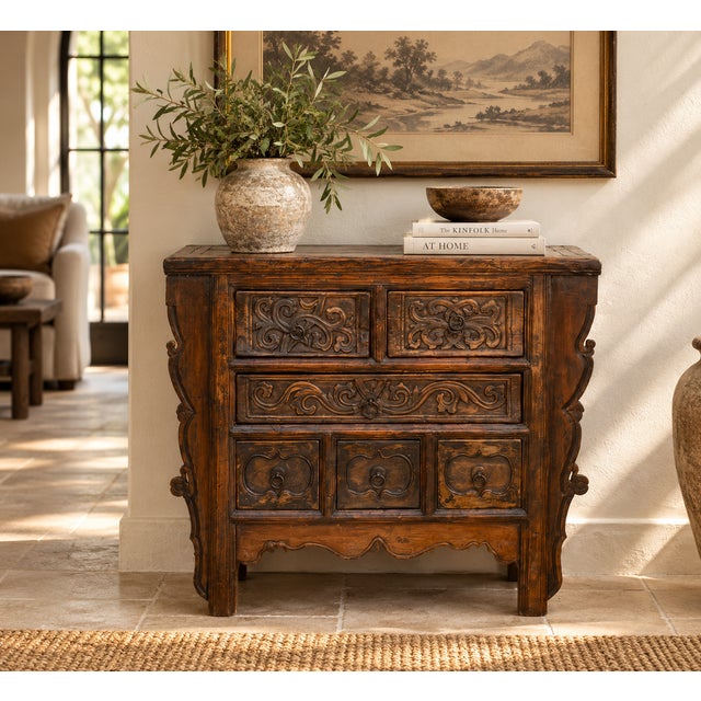 A small Chinese chest with six drawers, every front carved by hand, finished in a dark, waxed patina that has deepened...