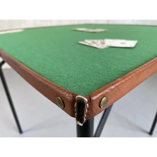 Jacques Adnet, folding game table in lacquered metal, brass and stitched leather, France 1950. The top is lined with green...