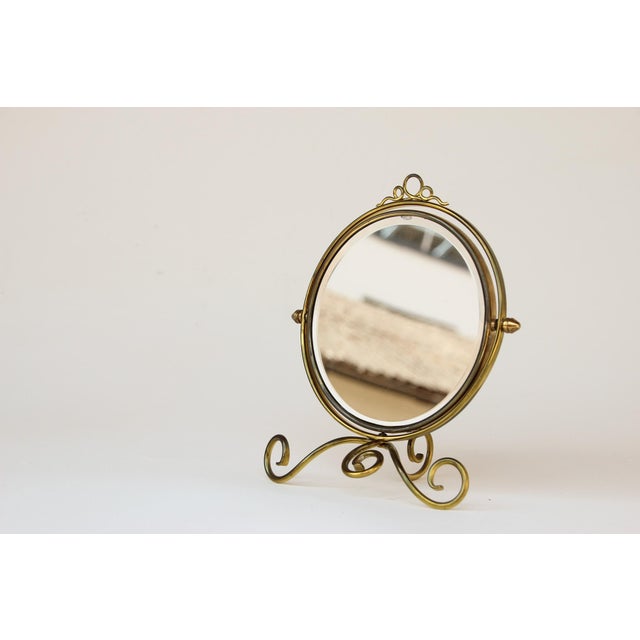 Antique English cosmetic mirror, made around 1910. The front features a standard mirror with a beveled edge; the back has...