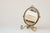 Antique English cosmetic mirror, made around 1910. The front features a standard mirror with a beveled edge; the back has...