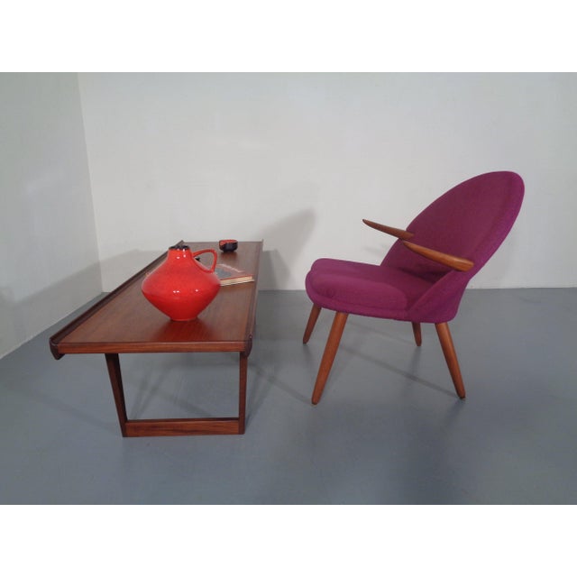 A gently organically shaped armchair by Kurt Olsen from the 1950s. The upholstery has been completely renewed, and the...