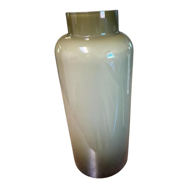 Bring sculptural elegance to your space with this tall olive-green glass vase featuring a milky white interior. Its glossy...