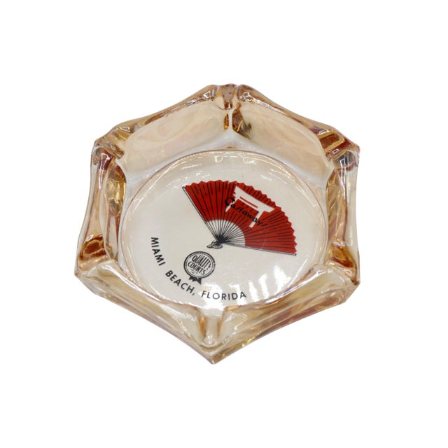 An hexagonal glass ashtray from The Castaways Hotel of Miami Beach, Florida. The center is printed with their logo and...