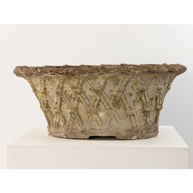 With a weathered patina and precise basket weave mould, this French mid-20th-century reconstituted stone planter adds...