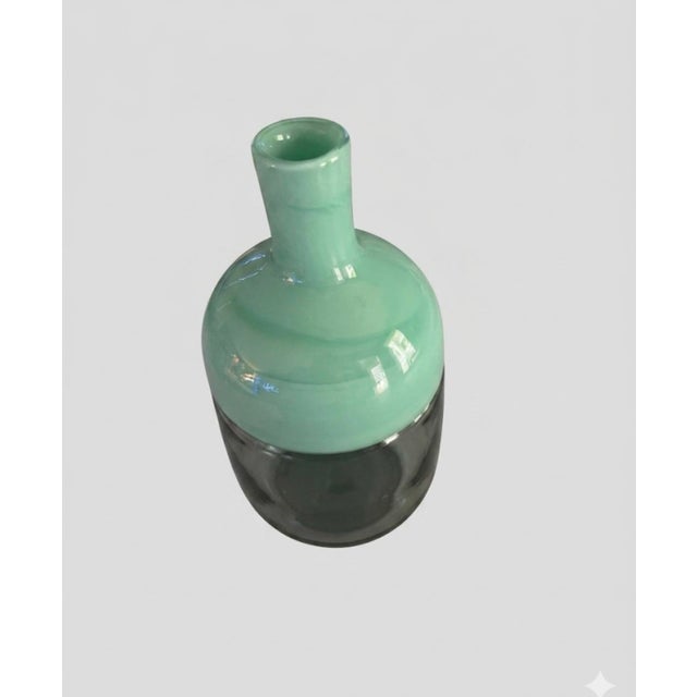 Elevate your space with this striking Mid-Century Modern hand-blown art glass vase, a retired piece from West Elm. It is a...