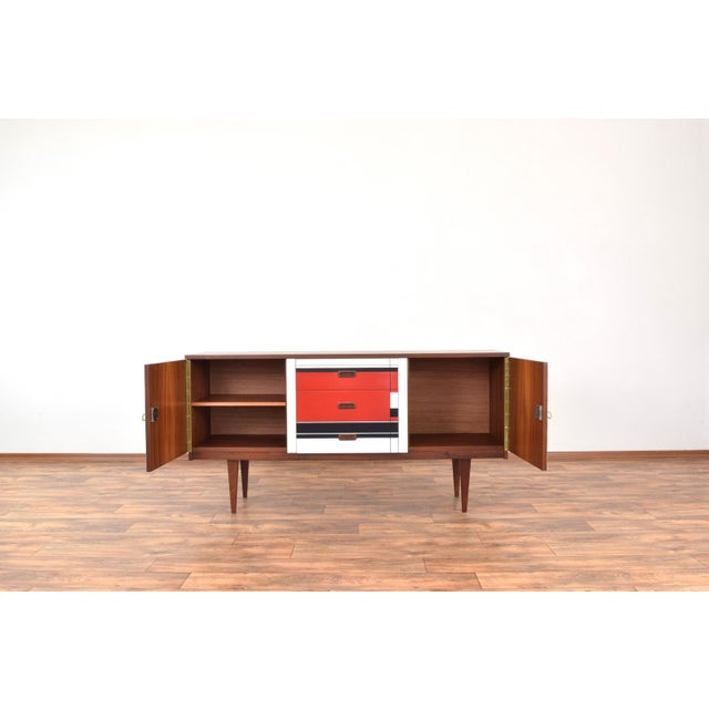 This walnut sideboard was made in Germany in the 1960s. The furniture has been professionally and carefully restored by...