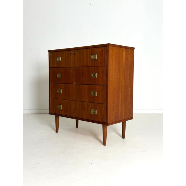 Danish Teak Chest of Drawers with Brass Handles, 1960s–70s A beautifully crafted Danish teak chest of drawers that...