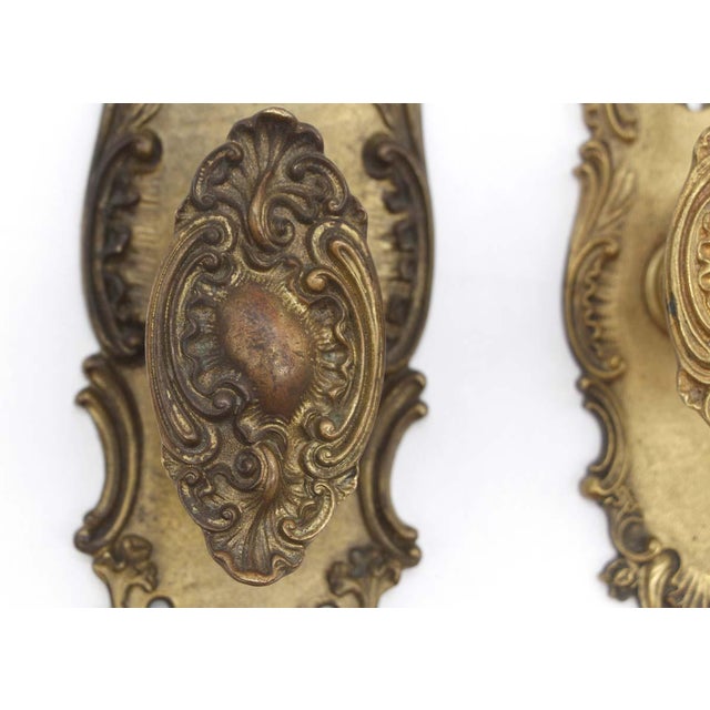 This antique bronze door knob set was made by Corbin in the 1905 catalog. It is a Rococo style. Part of the N-10600 St....