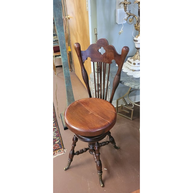 Unusual and rare antique Solid Piano stool Period Features adjustable seat Brass feet Clover Carved Crest rail And spindle...
