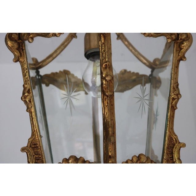 This exquisite French Louis XV style hanging lantern was crafted in the mid-20th century. The beautifully cast brass frame...
