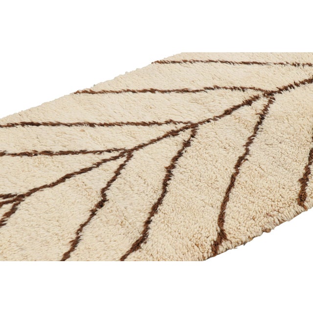 Hand-knotted in wool and originating from Morocco circa 1950-1960, this 3x6 vintage Moroccan rug is an extremely rare...