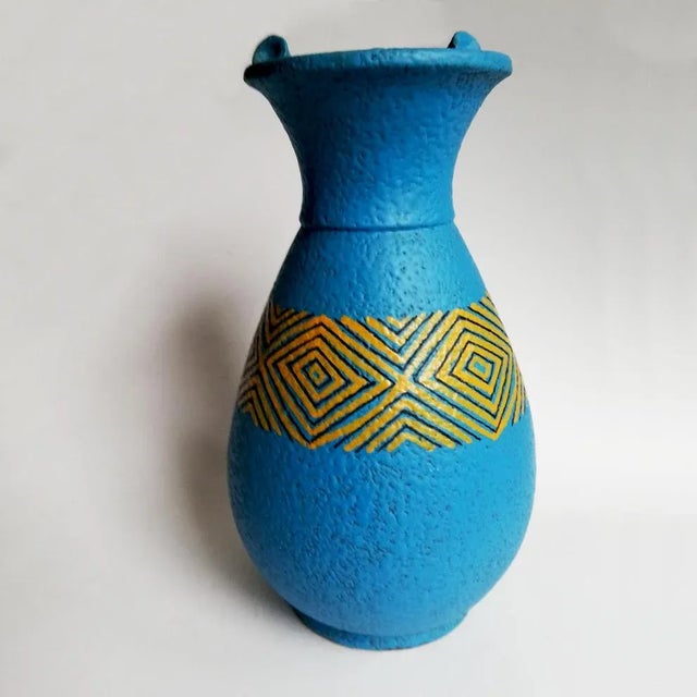 Jug vase with geometric decoration in yellow and black on a blue base, signed Casucci Chianciano