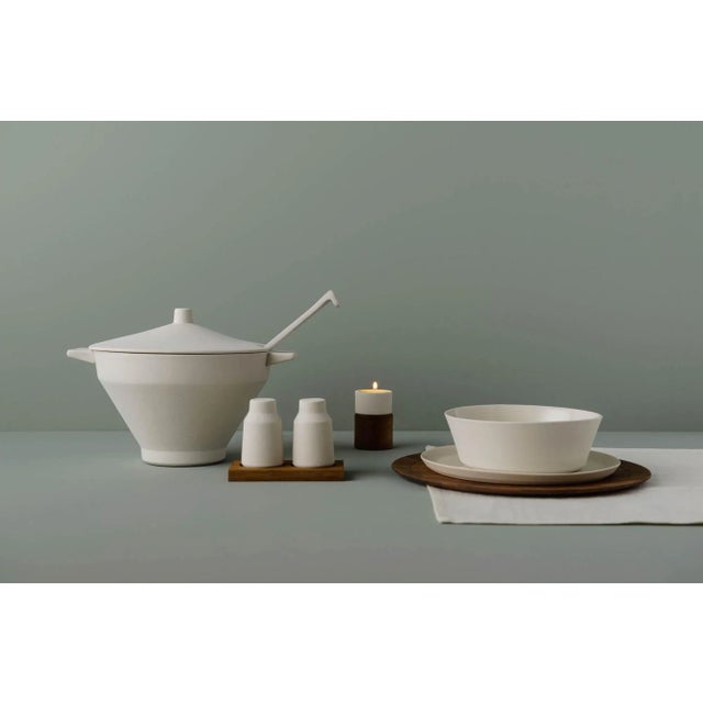 The set consists of a salt container and a ceramic pepper and a wooden tray. The tray, in national walnut wood, is shaped...