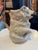 Antique French majolica pottery pitcher in the form of a blue-eyed, white bear holding a blue stick, wearing a studded...