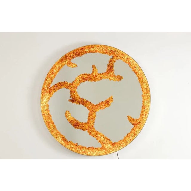 Backlit mirror in semi-precious stones, circular in shape, in amber tones. Work of French craftsman in small series. This...