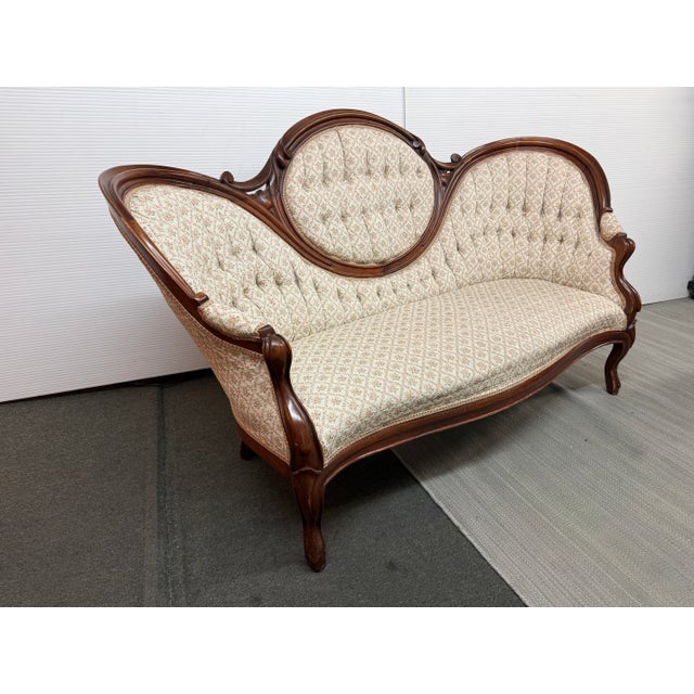 Design Plus Gallery presents an Antique Victorian Balloon Back Sofa. The charming sofa offers an upholstery of pink...