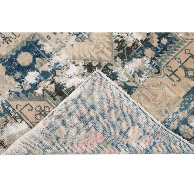 Beautiful Antique Heriz hand-knotted wool rug with a beige field. This Persian rug has a subtle blue accent featuring an...