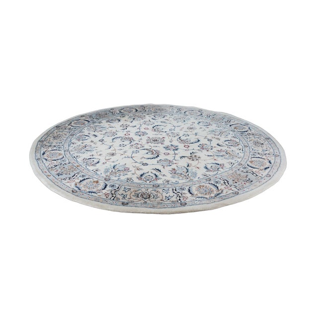 Vintage round hand-knotted Nain style wool and silk area rug featuring ivory field with blue/navy floral all-over vine and...