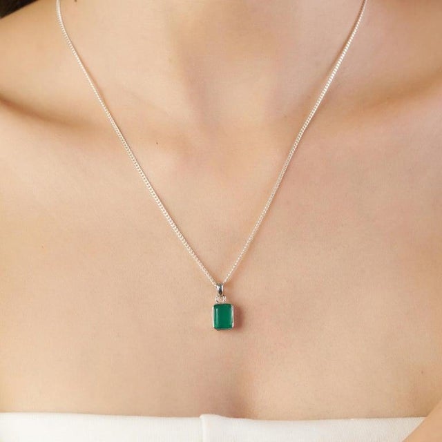 Featuring a 6×8 mm octagon-cut green onyx gemstone weighing 1.84 carats, this 925 sterling silver pendant showcases a...
