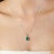Featuring a 6×8 mm octagon-cut green onyx gemstone weighing 1.84 carats, this 925 sterling silver pendant showcases a...