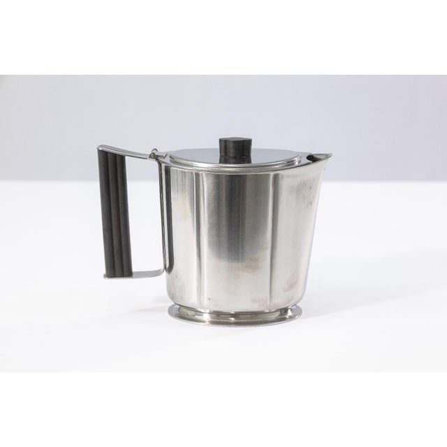 Georg Jensen serving set including a stainless steel knife and forks, together with a pair of Gense stainless steel...