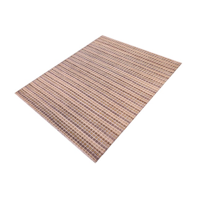 Elevate your interior with this hand-knotted high-low wool area rug, designed to bring depth and dimension to any room....