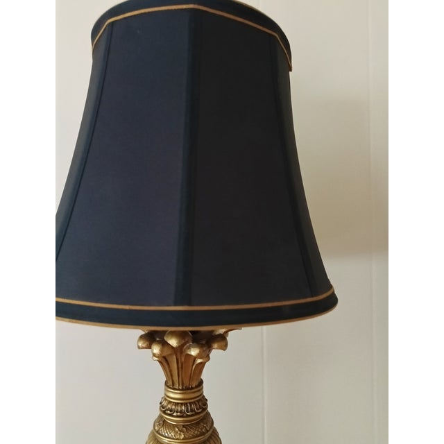 Elevate any room with this striking vintage table lamp featuring a dramatic black lacquered column, warm gold accents, and...