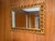 Description direction: Striking vintage carved giltwood wall mirror featuring an ornate scrolling frame with a beautifully...