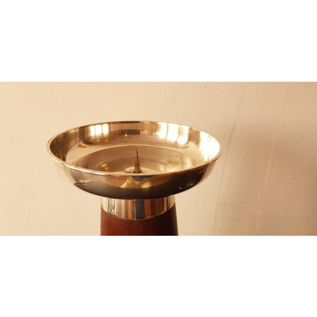 This teak candleholder features a silver top. This piece has an attribution mark, I am sure that it is completely...