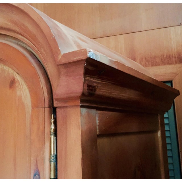 A striking Spanish Baroque revival armoire crafted by Romweber Furniture of Batesville, Indiana. Features an arched bonnet...