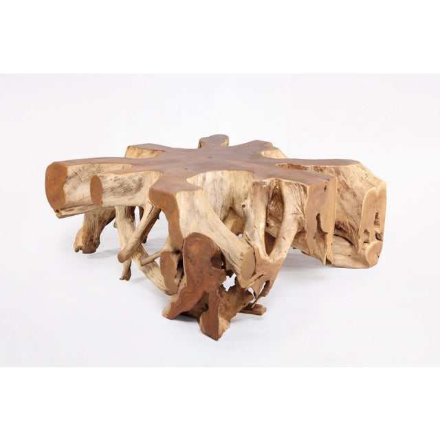 Inspired by the beauty of natural root form, this organic teak coffee table is handcrafted from one piece of salvaged teak...