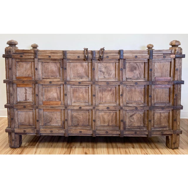Monumental antique Anglo-Indian Damchiya, or dowry chest. Stunning carved Burmese teak with hand forged iron strap work,...