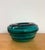 A sculptural vintage art glass bowl in a rich emerald-teal tone, featuring a low rounded form with thick, heavily molded...