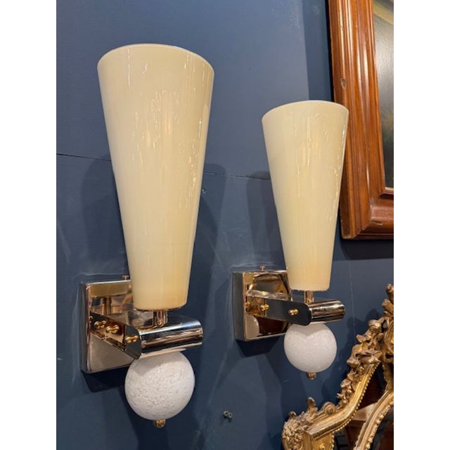 Pair of modern Italian Murano glass and brass cone form sconces. Murano cone sconces are a sleek, modern interpretation of...