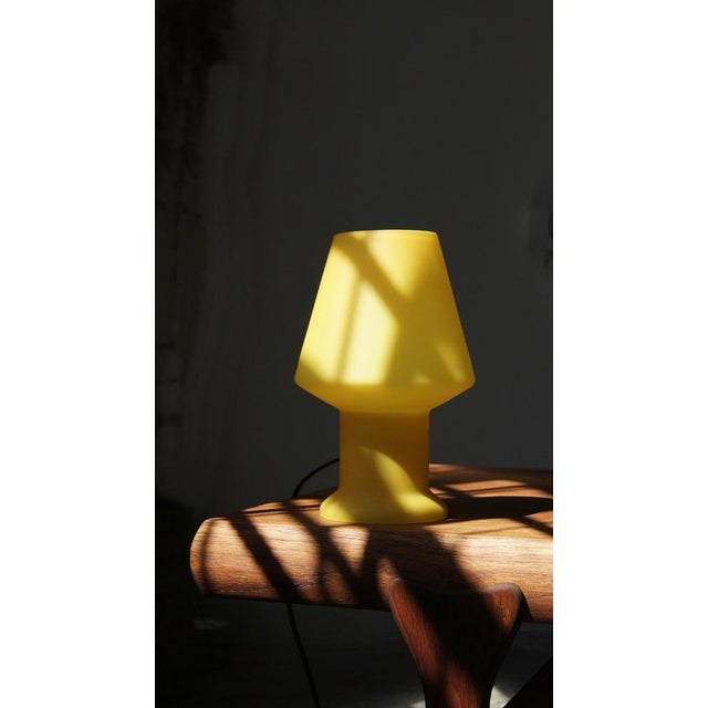 This unusual table lamp made of yellow Murano glass dates back to the 1970s and is a beautiful example of Italian...