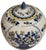 A vintage Chinese porcelain lidded ginger jar, featuring blue and yellow hand-painted floral panels. Chinoiserie floral...