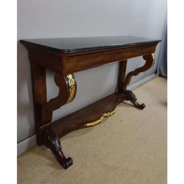 Large Restoration period console table. This console opens with a large drawer; the top is covered in black Belgian...