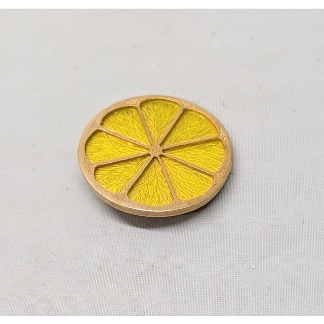 1967 goldtone yellow translucent enamel lemon slice brooch with security clasp. Marked "NAPIER©" on the back. Measures: 1...