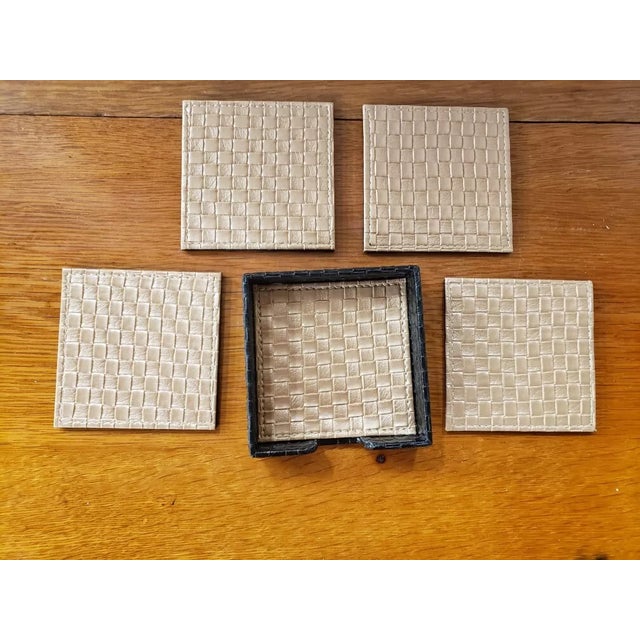 This is a Set of 4 Vintage Woven Leather Drink Coasters in Holder. Each measures 4" x 4". The pieces are in excellent...