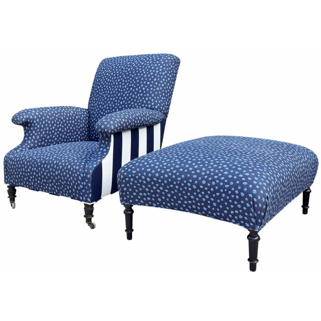 Antique English-style upholstered armchair and oversized ottoman with an unusually sculptural silhouette. The chair...