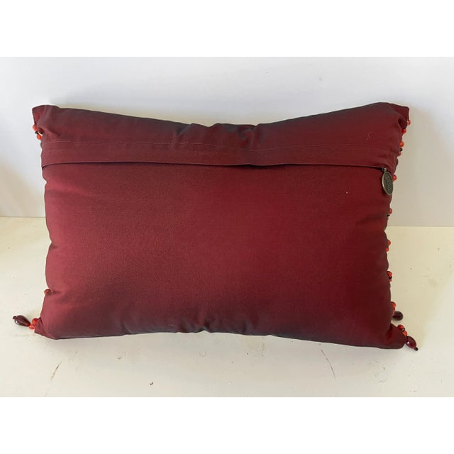 Vintage embroidered tapestry floral lumbar pillow with beaded side tassels. Vine red silk on the back.
