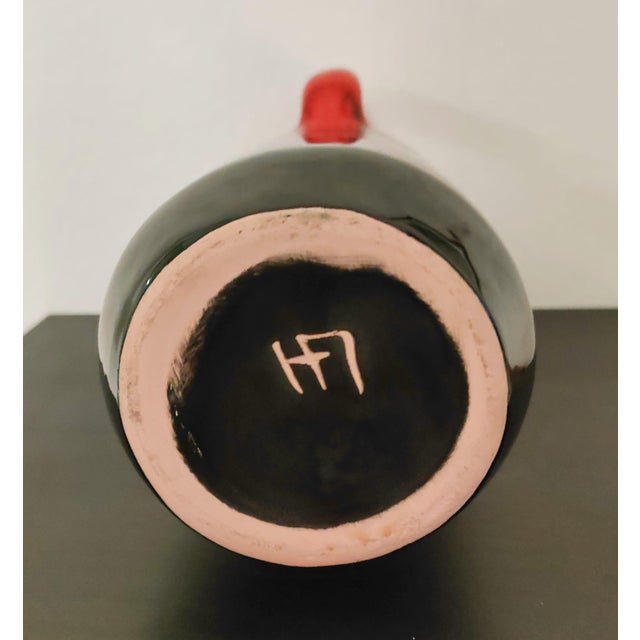 A classic 60s design. Vase with handle by Fat Lava in the classic "Sundown" decoration from the 1960s, with a rough black...