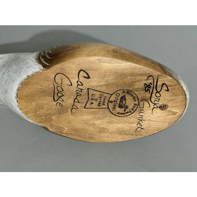 Bring rustic charm and classic wildlife artistry into your home with this **Vintage Wooden Bird Factory Canadian Goose...