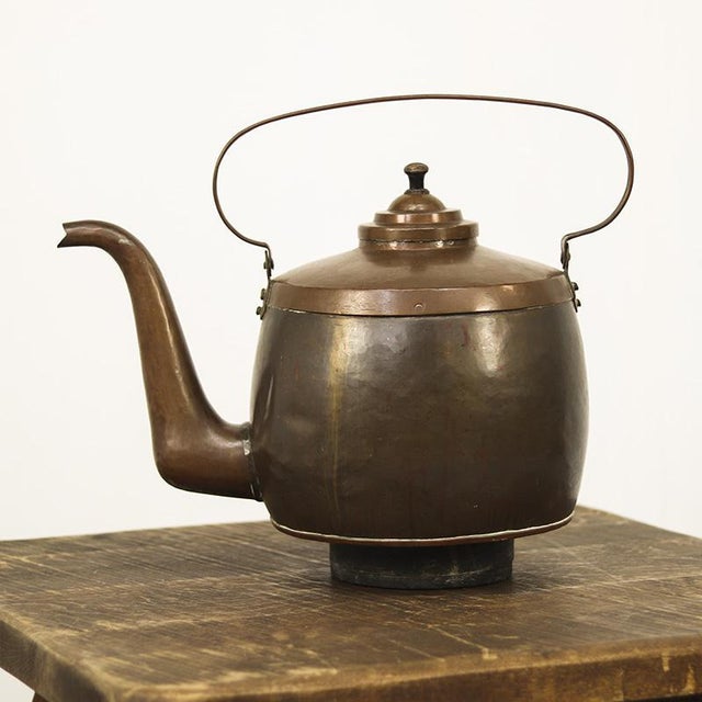 Exceptionally large red copper teapot from the 19th century, hand-finished with a hammered effect. The rich, weathered...