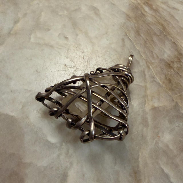 For your consideration, a wire-wrapped pendant featuring a raw gemstone, specifically resembling a clear or rutilated...